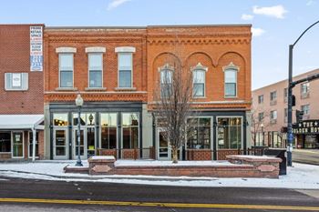 A red brick building with a signature at The Avenue Lofts Golden Apartments, Golden 80401